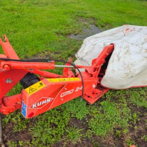 Used Kuhn GMD 240 disc mower with PTO and side cutter in working condition on grassy field