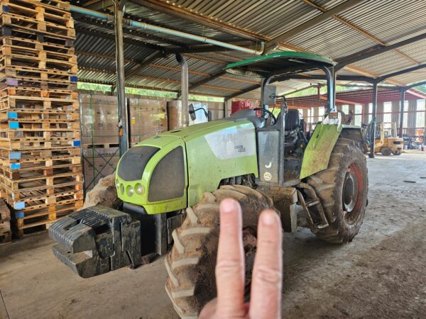 Second used Claas Celtis 456 4x4 tractor in muddy working condition, photographed indoors at a farm equipment facility in KwaZulu-Natal, South Africa.