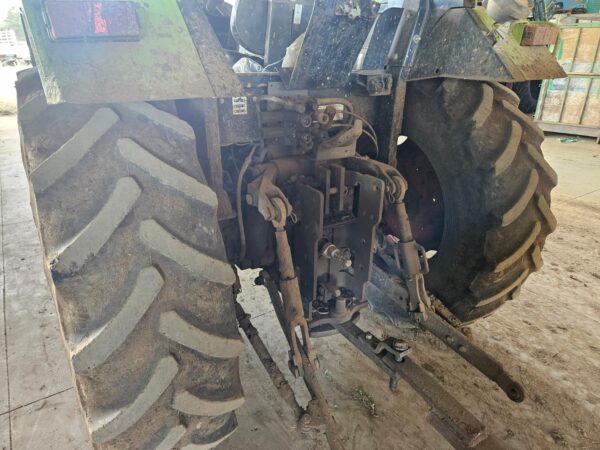 Second used Claas Celtis 456 4x4 tractor in muddy working condition, photographed indoors at a farm equipment facility in KwaZulu-Natal, South Africa.
