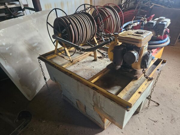 Used Bakkie Sakkie water cart mounted on bakkie tray with pump, hose reel, and tank for firefighting or farm irrigation tasks.