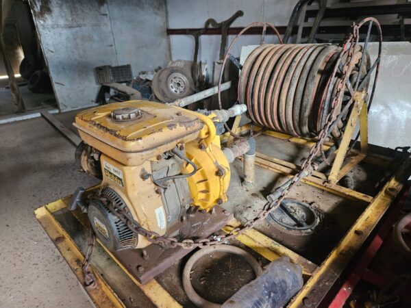 Used Bakkie Sakkie water cart mounted on bakkie tray with pump, hose reel, and tank for firefighting or farm irrigation tasks.