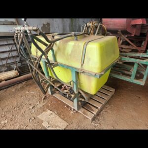 Photo of pre‑owned yellow 600 L mounted spray tank—HDPE tank, frame mounted, hoses and pump fittings visible, ready to mount